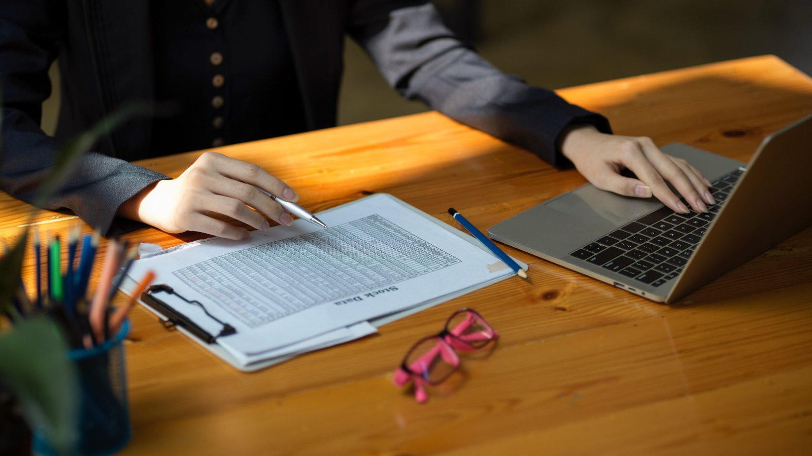 Cropped shot of a business woman checking her stock data report paperwork at her office desk.