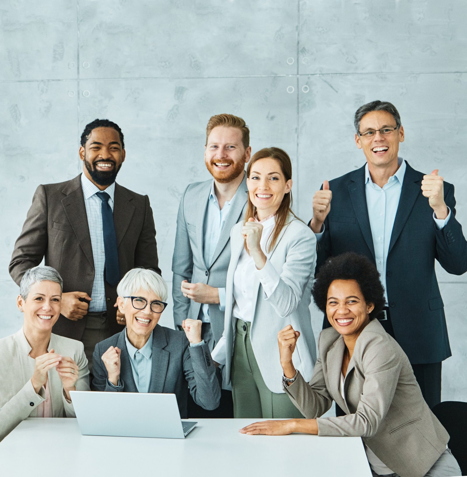 Portrait of a group of happy young and senior business people having a meeting and celebrating success in the office. Teamwork and success concept